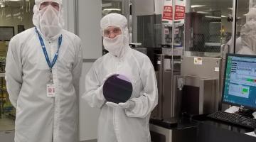 MIT researchers demonstrated a method to manufacture carbon nanotube transistors in commercial facilities that fabricate silicon-based transistors. This photograph shows Anthony Ratkovich, left, and Mindy D. Bishop, who is holding an example of ...